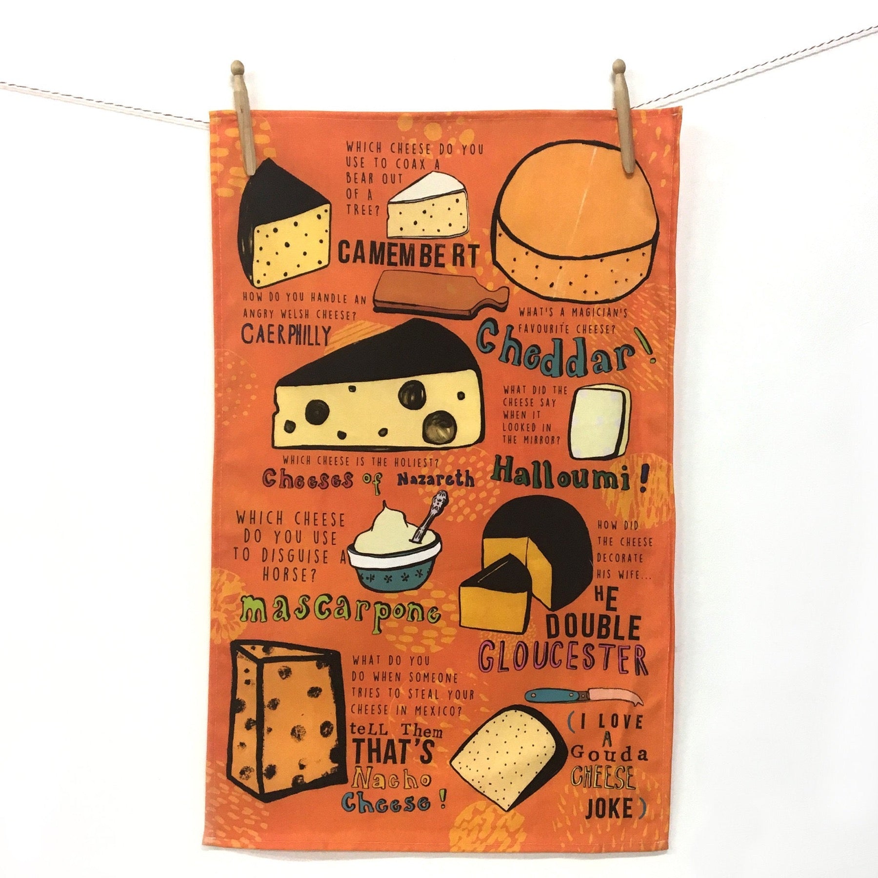 an orange tea towel with cheese themed jokes and images 